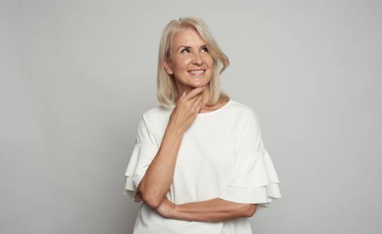 portrait of a beautiful 50 years woman is smiling, looking up
